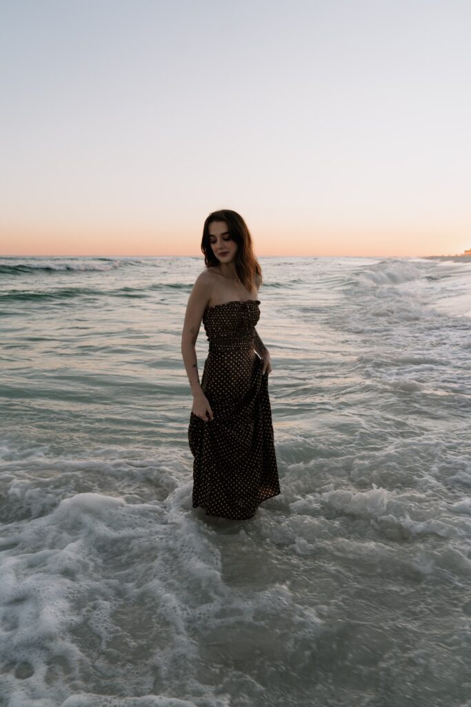 Pensacola wedding photographer standing in the water at Pensacola Beach.