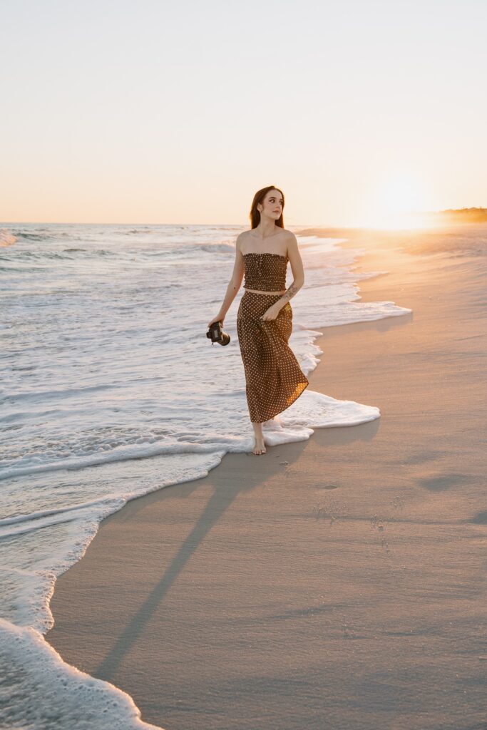 Pensacola wedding photographer walking along the water at Pensacola Beach.