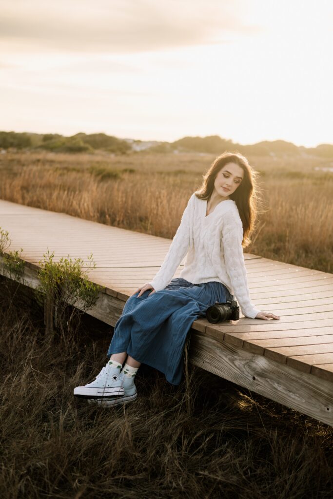 Pensacola wedding photographer sitting on the boardwalk at Fort Pickens on the Florida Panhandle.
