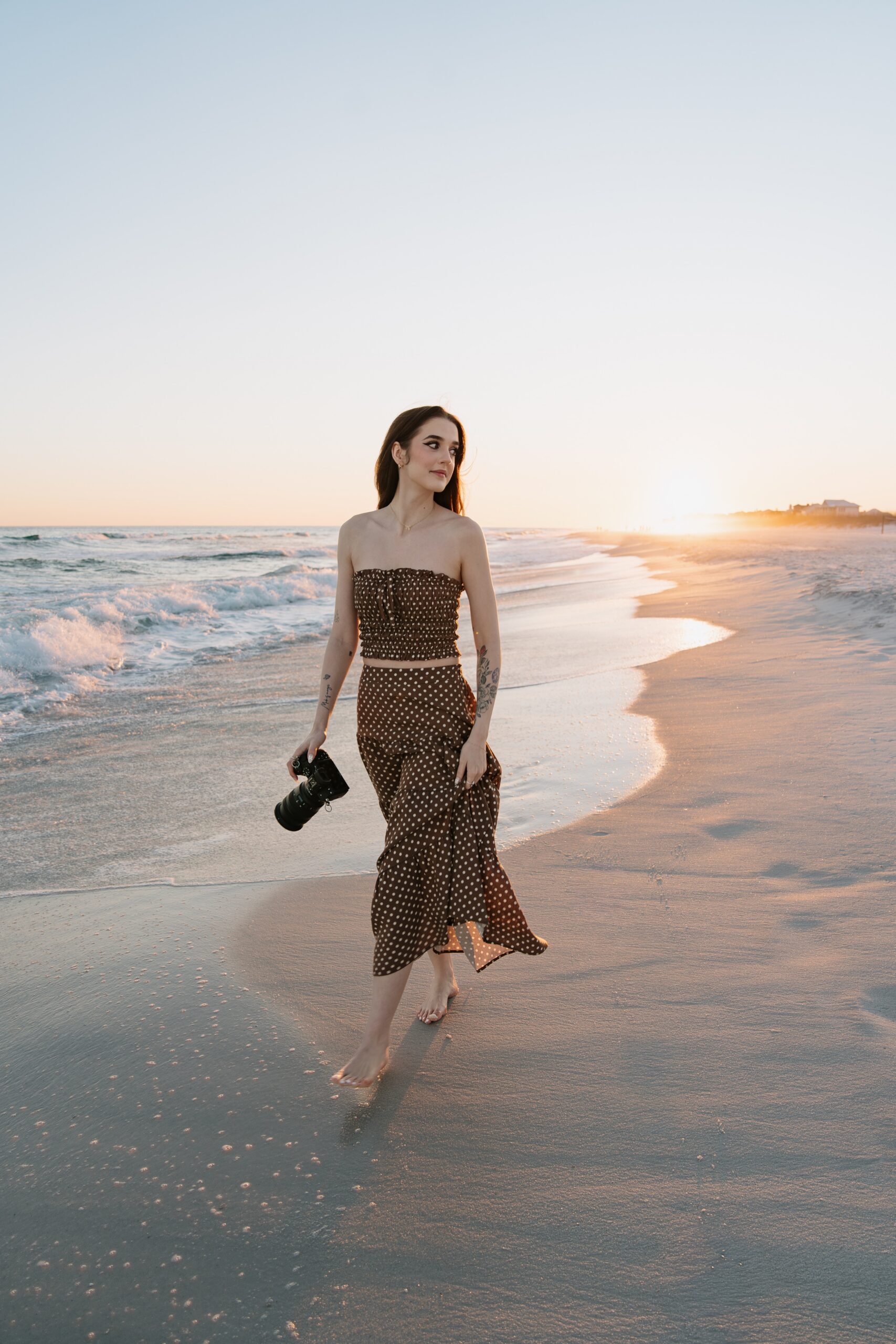 Pensacola wedding photographer walking along the water at Pensacola Beach.
